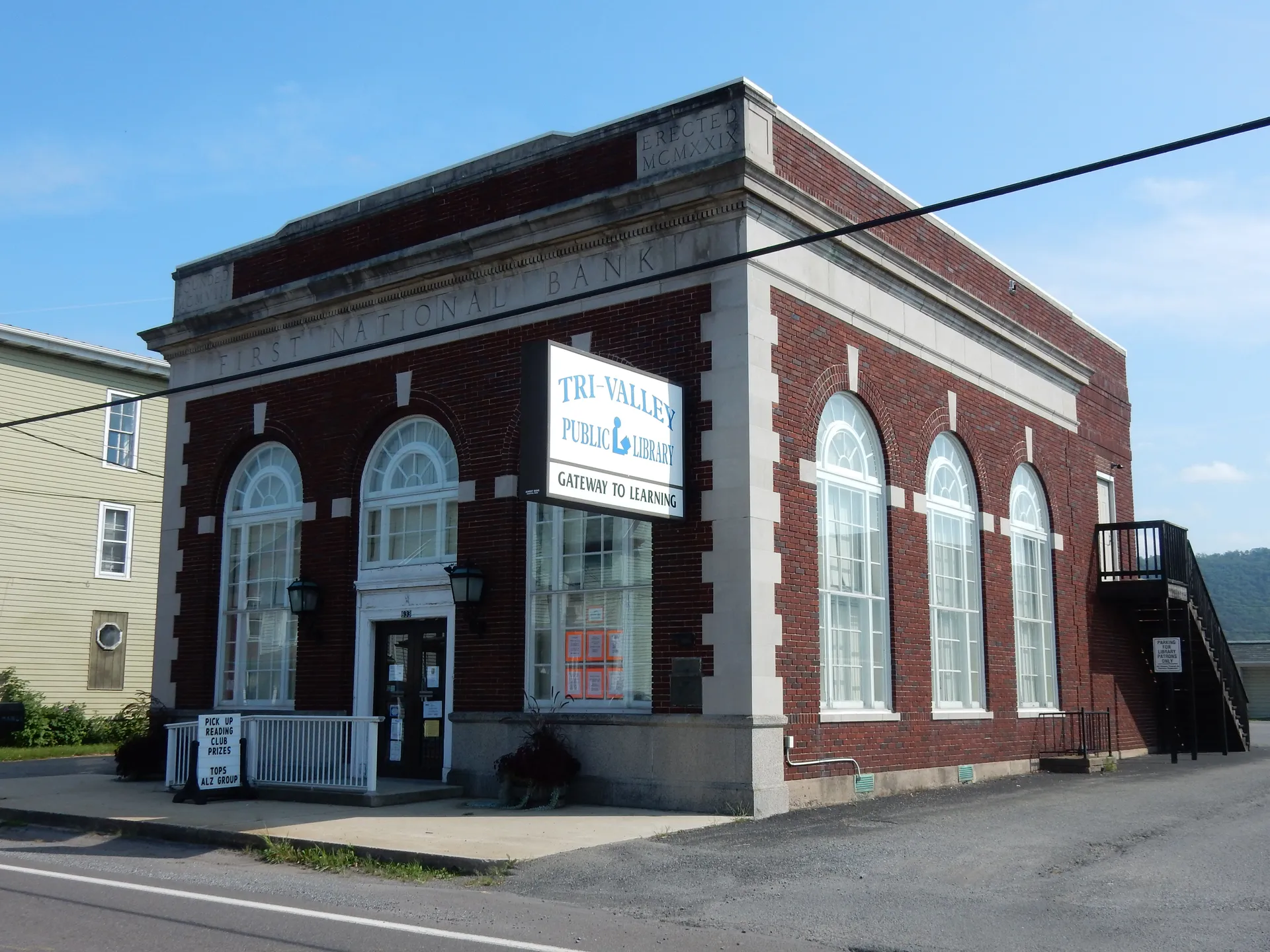 Hegins' Tri-Valley Public Library is a small brick building with tall arched windows and a front porch on East Main Street.