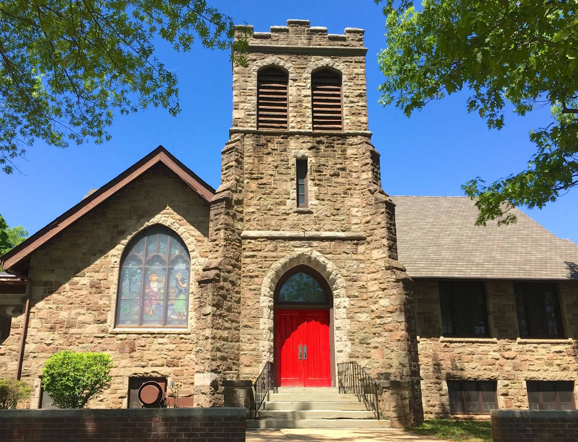 Middlebush Reformed Church has a square stone bell tower with arched openings above its gabled front.