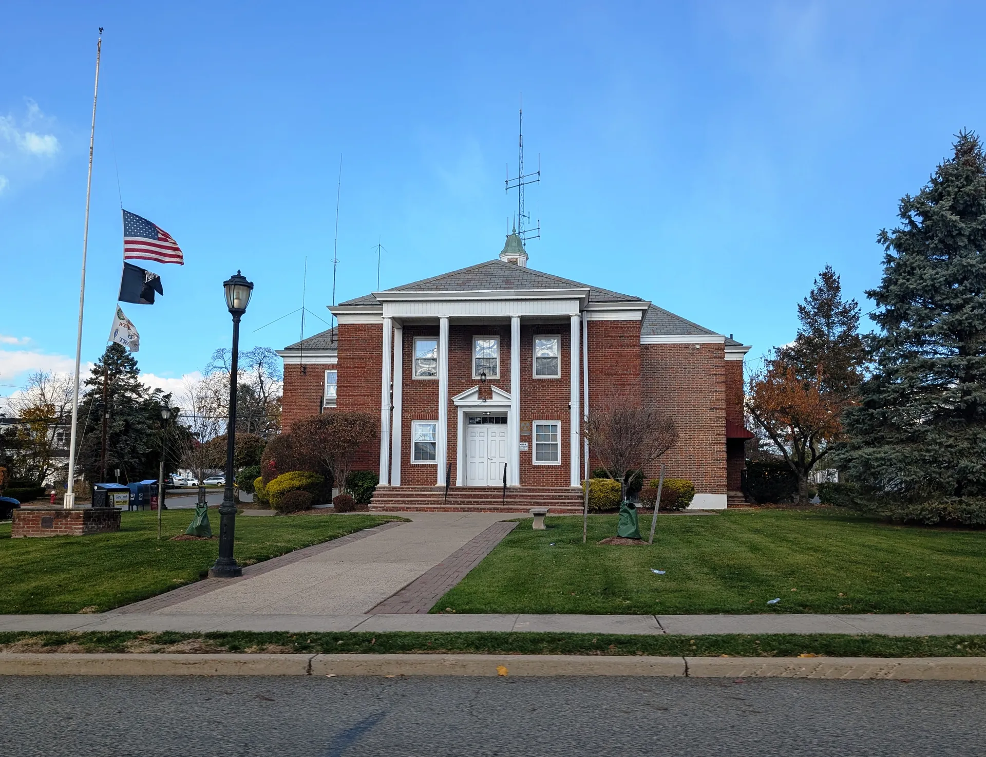 Emerson's municipal building is a red brick colonial with a white columned portico, a weather vane and a front walk with lampposts.