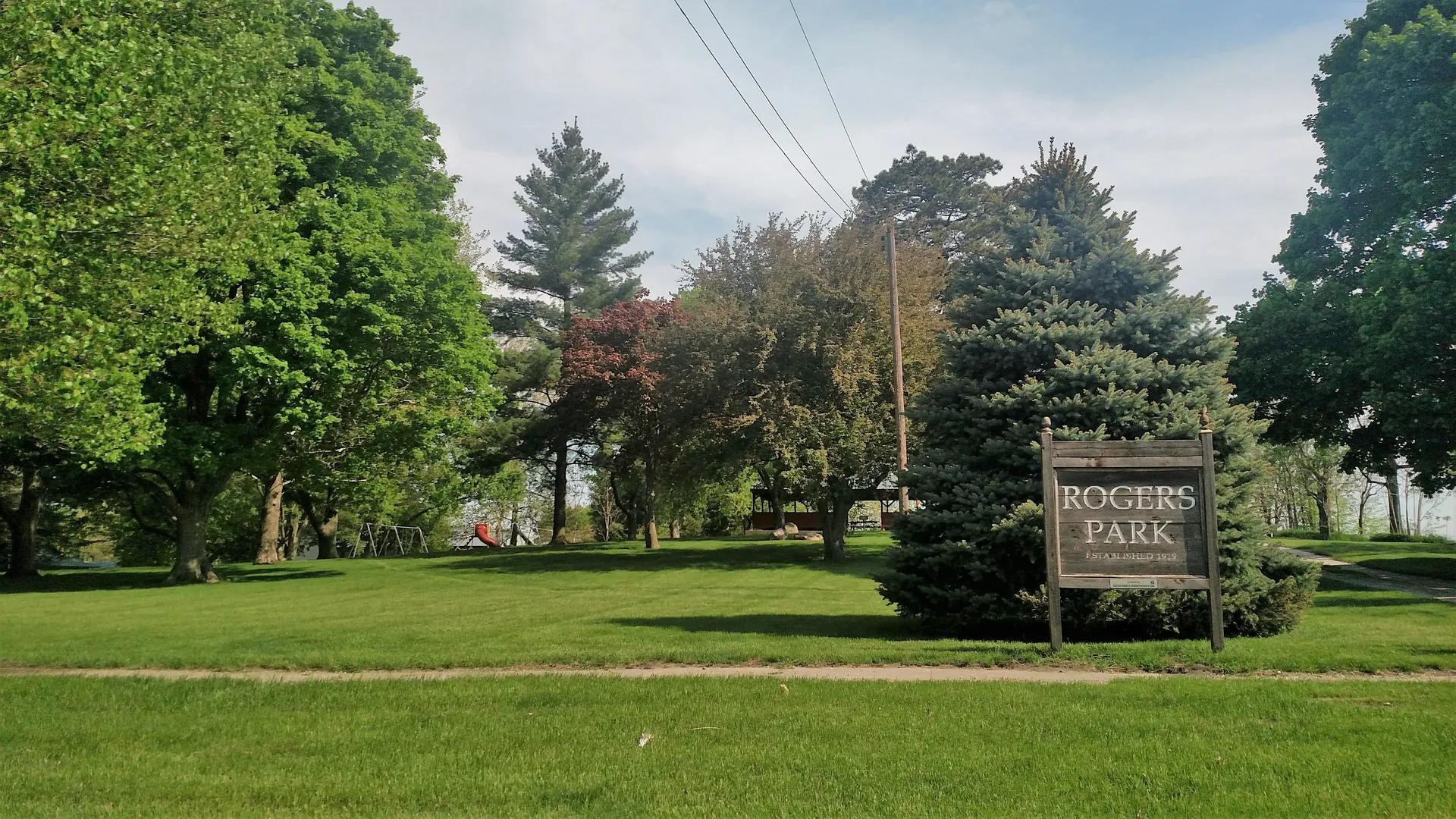Green park with mature trees in Minburn, Iowa.