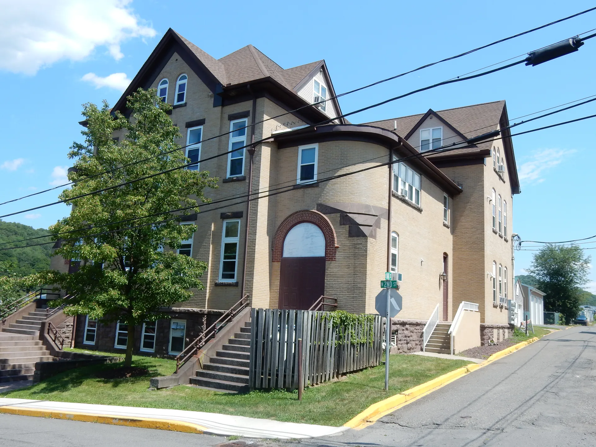 Girardville Towers, a large Victorian brick building with gables, stands on North 2nd Street in Girardville.
