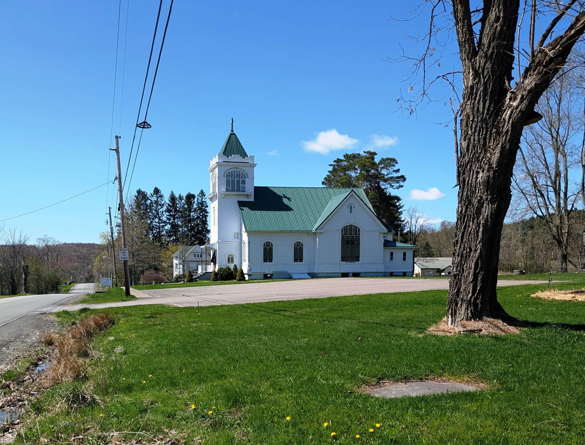 St. Francis Xavier Church in Friendsville is a white church with a tall belfry and green roof at Lake and Main streets.