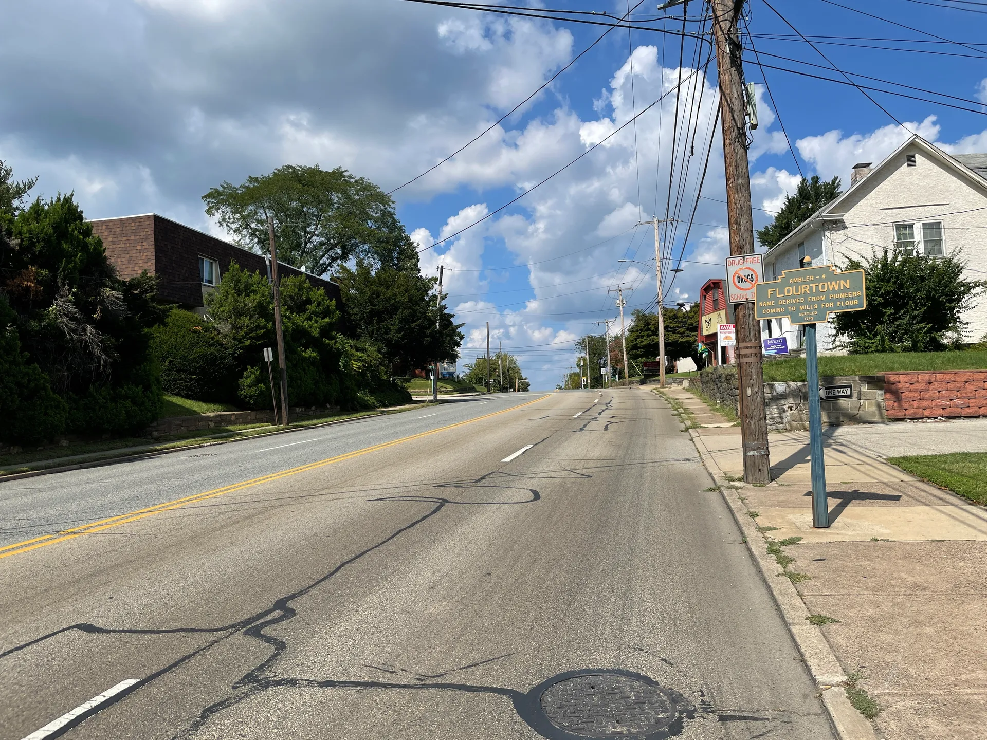 Bethlehem Pike in Flourtown climbs north past Haws Lane, with sidewalks, shade trees and a mix of homes and businesses.