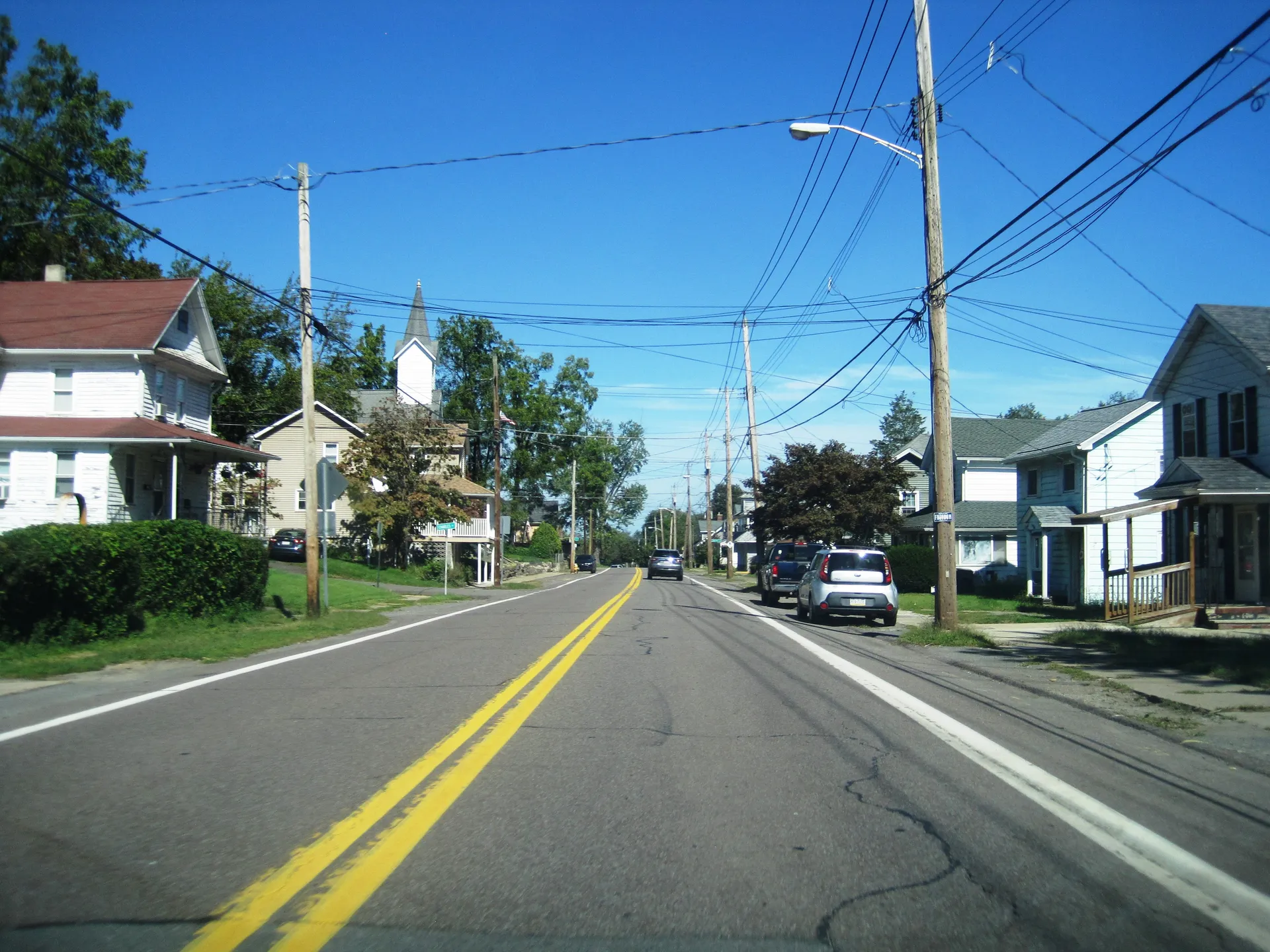Courtdale Avenue in Courtdale heads southwest between Hoyt and Charles streets, with houses and a white church steeple ahead.