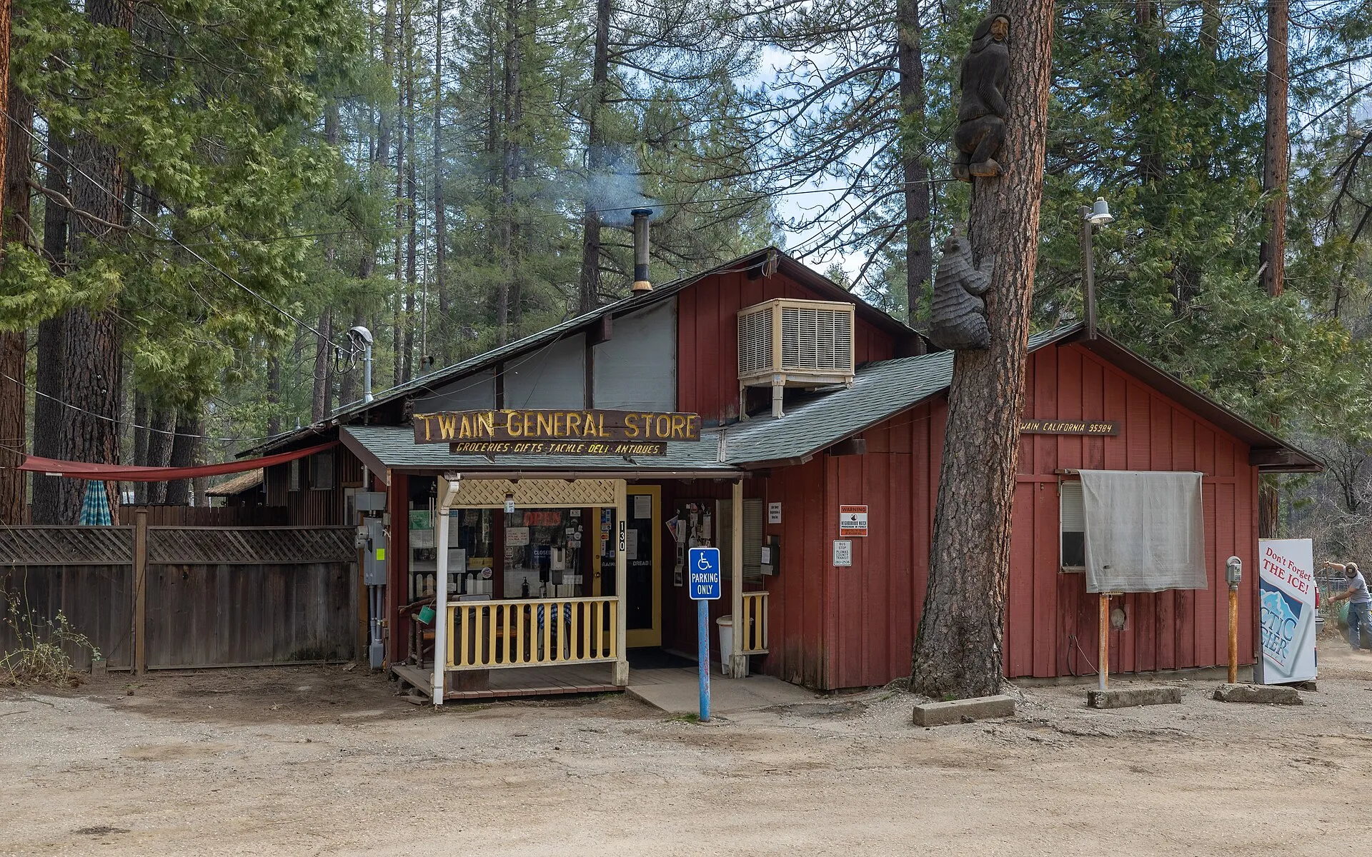 Rustic red Twain General Store among pines in Twain, Plumas County, California.