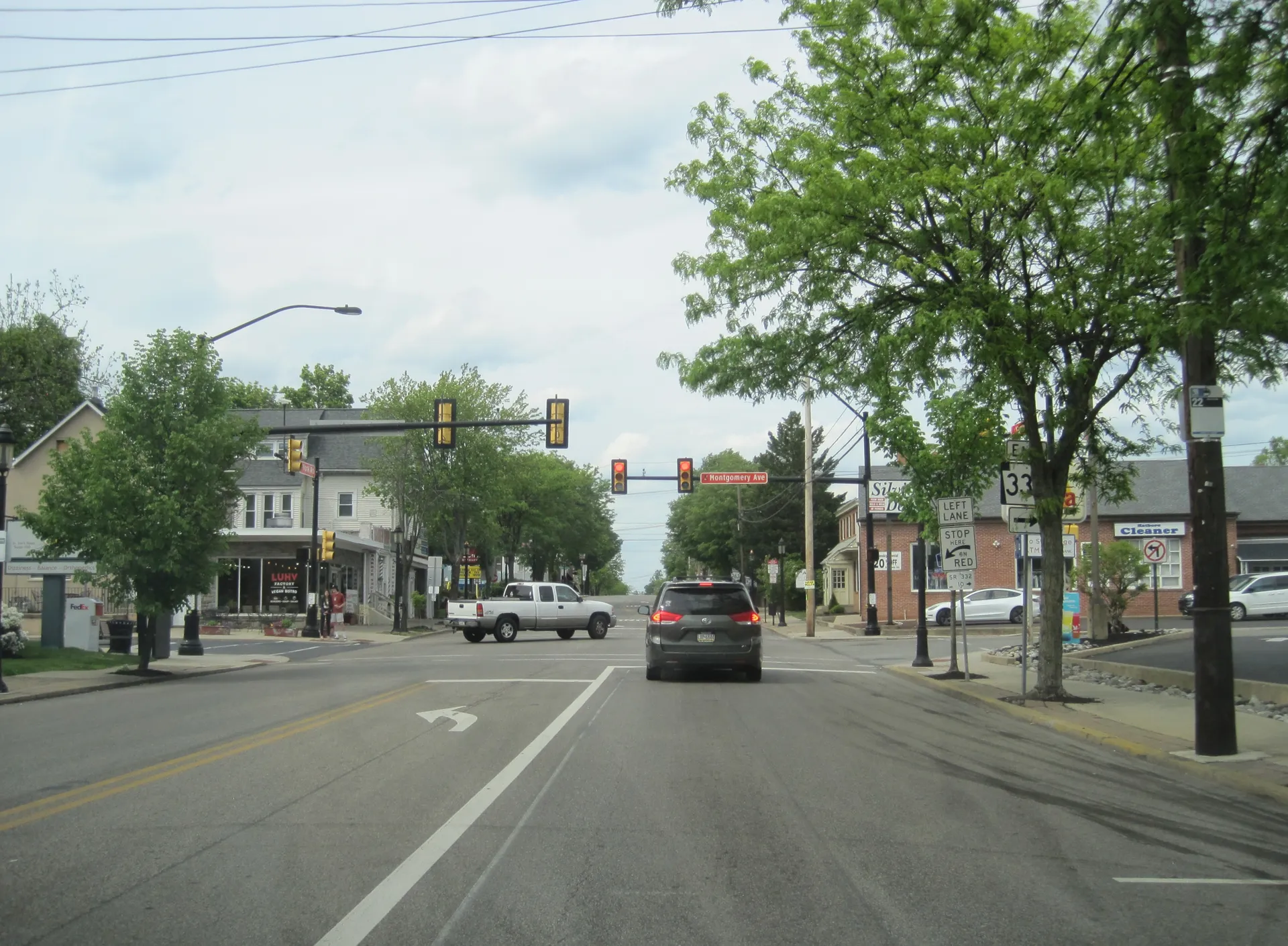 York Road and Montgomery Avenue meet in downtown Hatboro, where storefronts and leafy trees line the sidewalks.