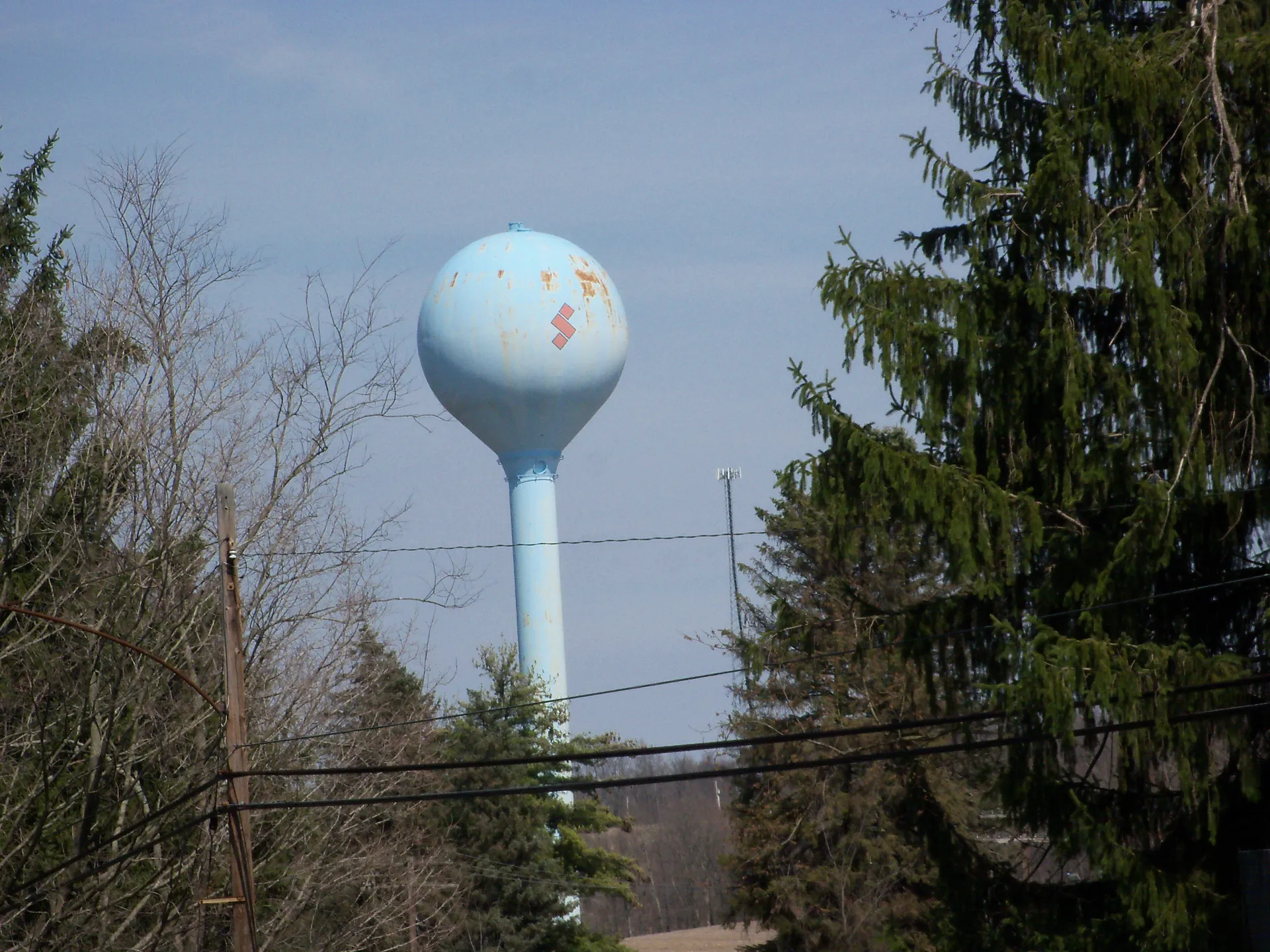 Tile water tower above the trees in Summitville, Ohio.