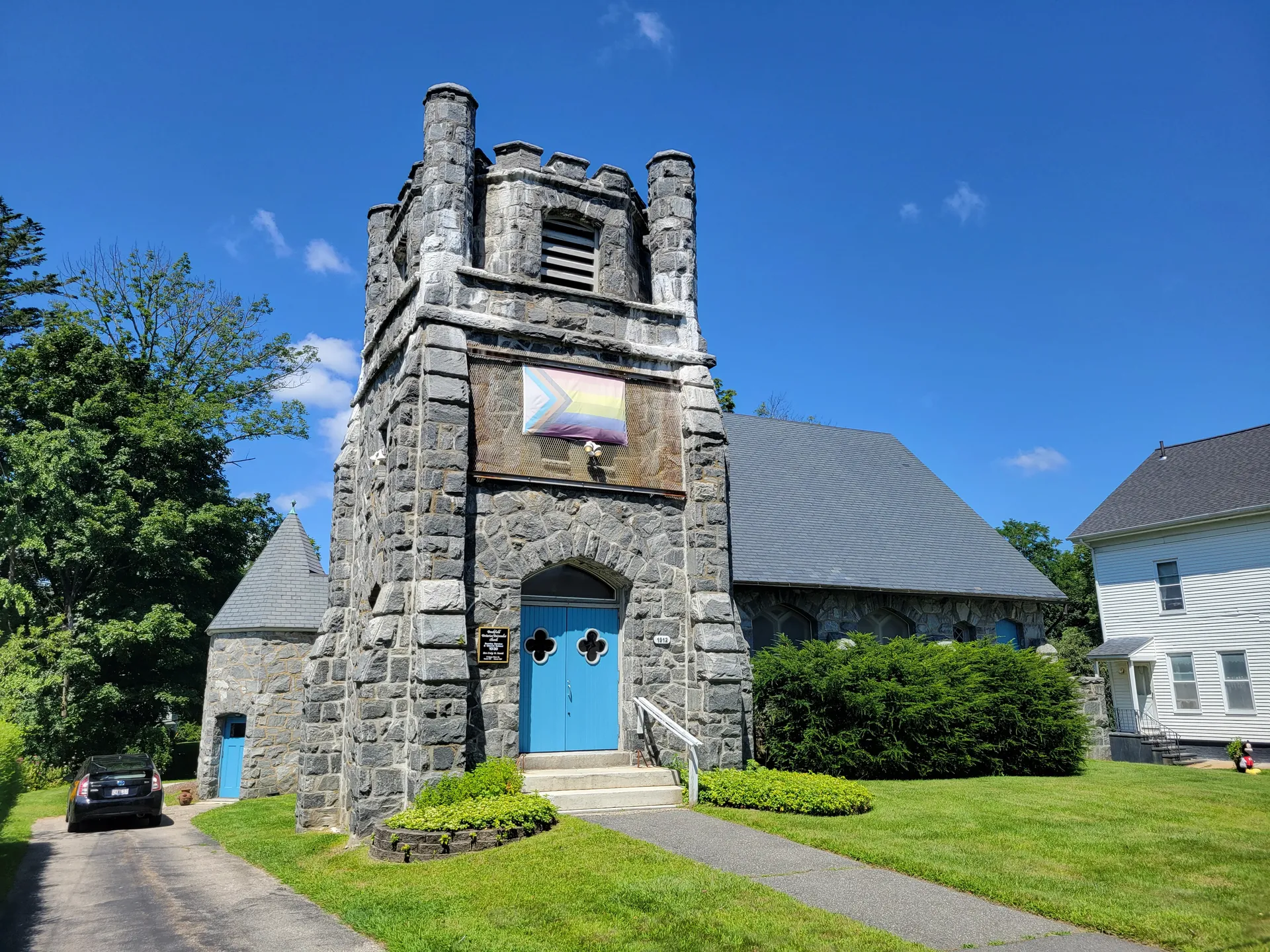 Stone bell tower of the First Parish Unitarian Universalist Church in Brookfield, Massachusetts.