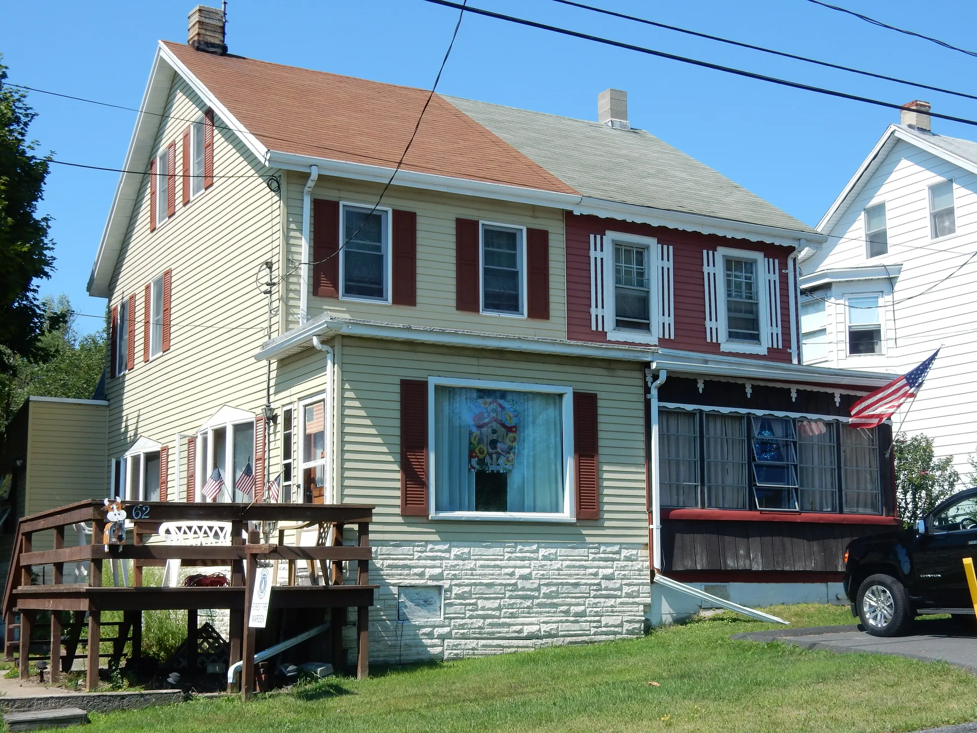 A two-story home with dark red shutters and a side deck stands on Lakeside Avenue in Delano, Schuylkill County.