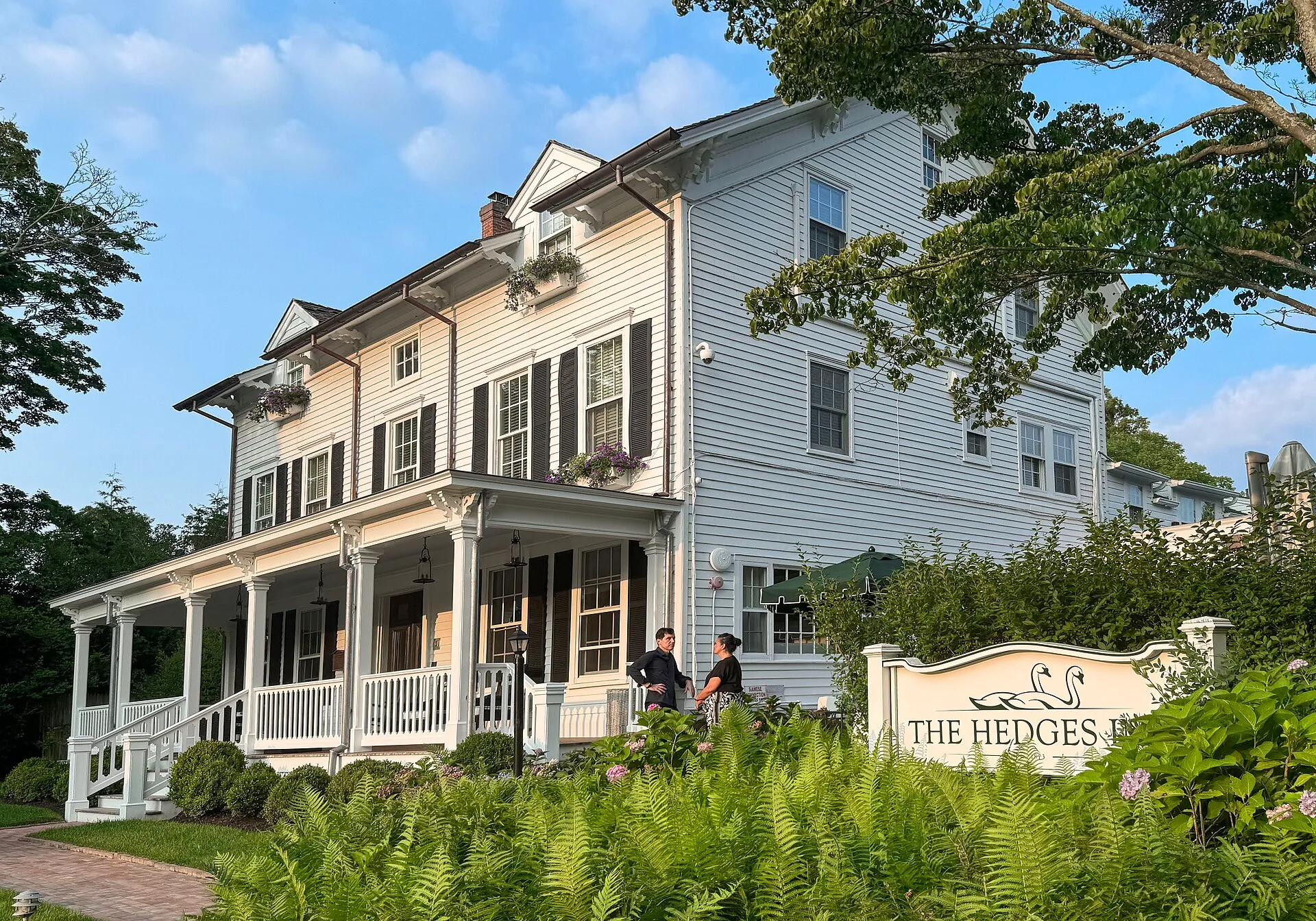 Historic Hedges Inn with a long front porch in East Hampton, New York.