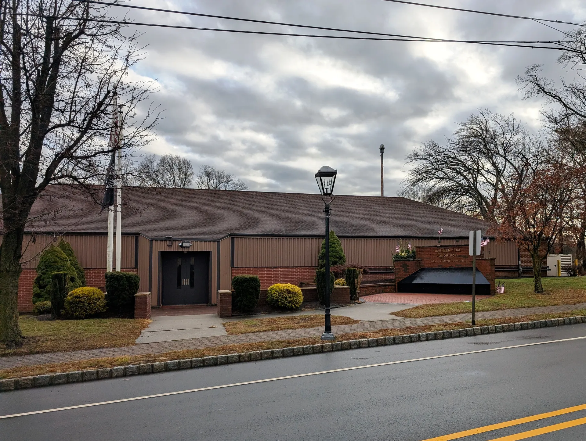 The New Hanover Township municipal building in Cookstown is a low brick structure with a lamppost and a small front walk.