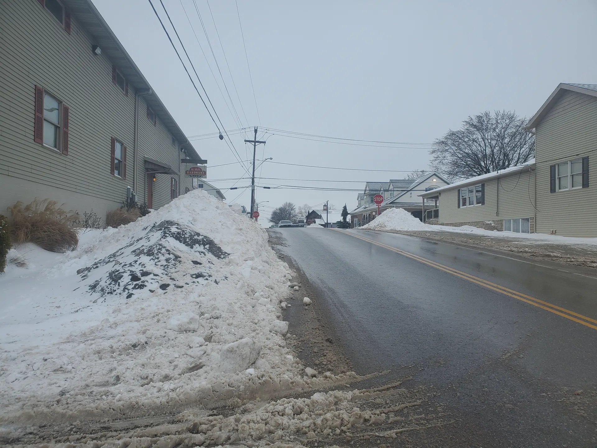 Snowy street with homes in Mount Hope, Ohio.