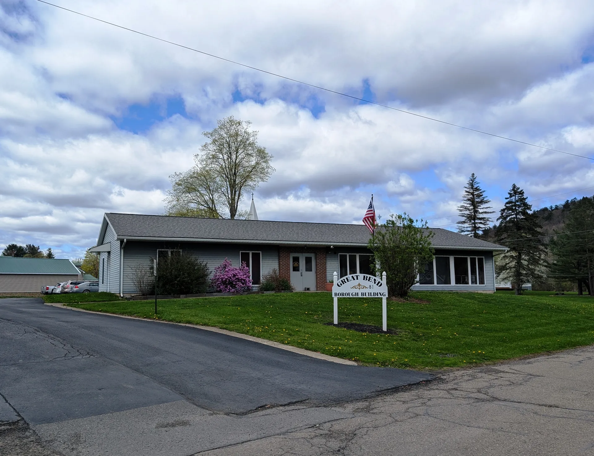Great Bend's Borough Building is a single-story brick building with a white sign and landscaped lawn on Elizabeth Street.