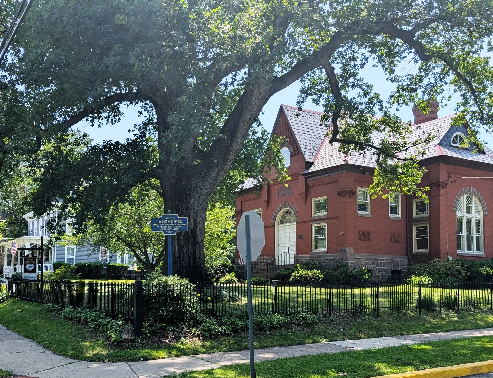 The red-brick Langhorne Library stands under a giant shade tree on Maple Avenue, beside the borough's Keystone marker.