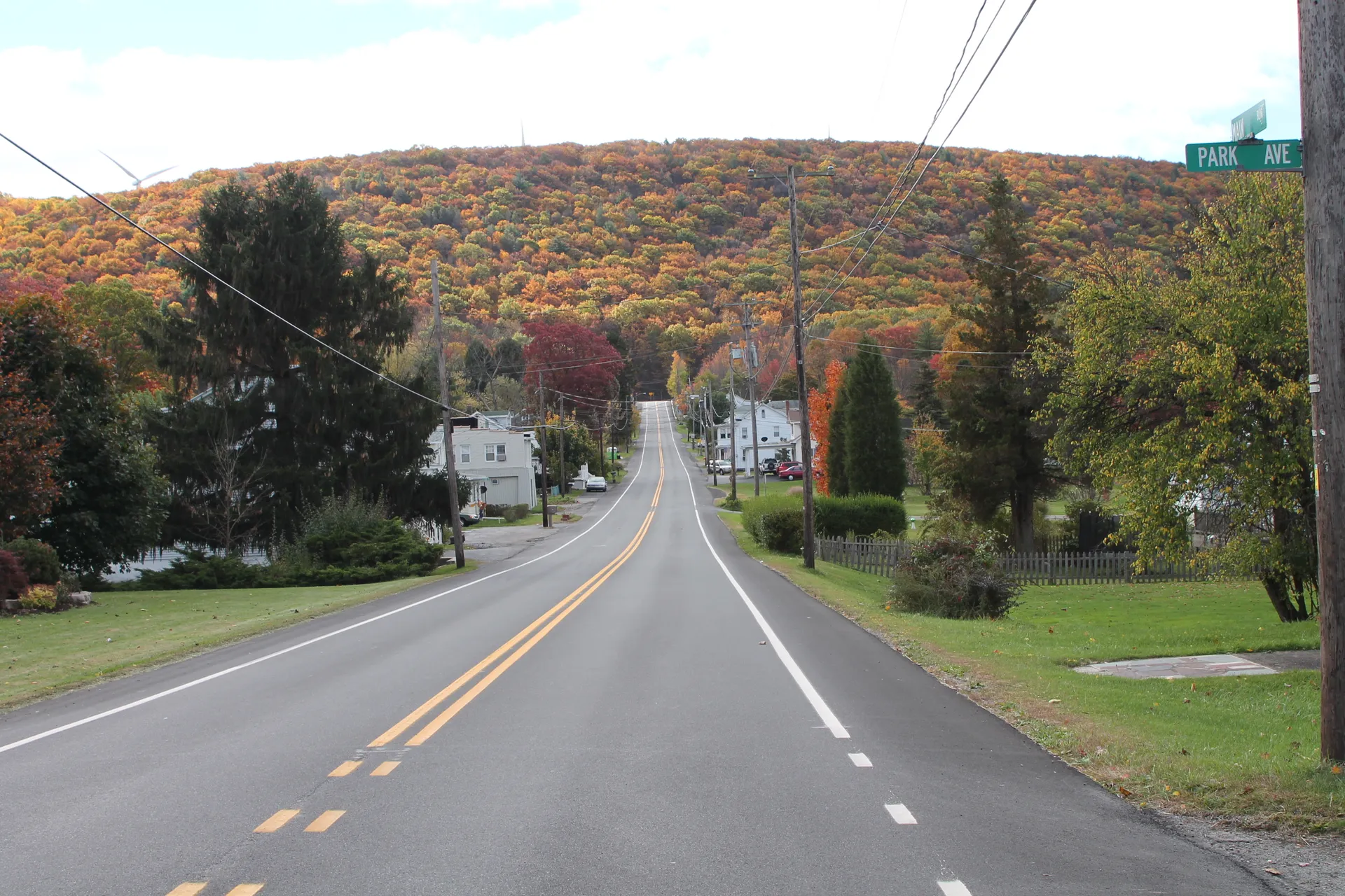 Routes 339 and 924 run together through Brandonville, where scattered homes sit at the foot of a hillside blazing with fall color.