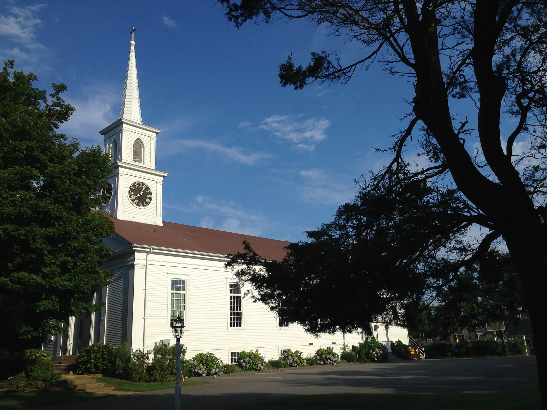 White Grace Church with tall steeple in East Dennis, Massachusetts.