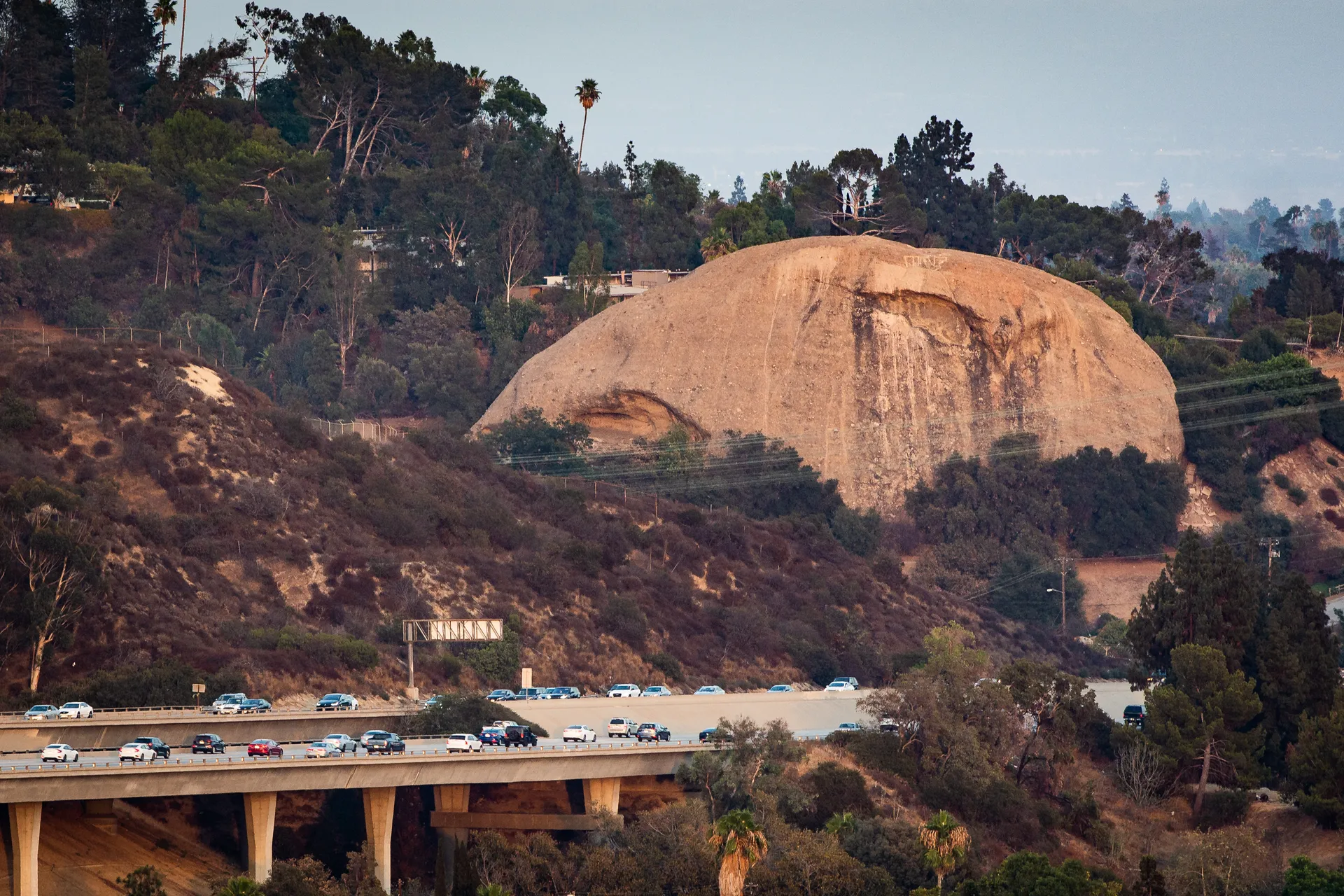 The Eagle Rock sandstone landmark at dusk, with an eagle-shaped dark marking across its face.