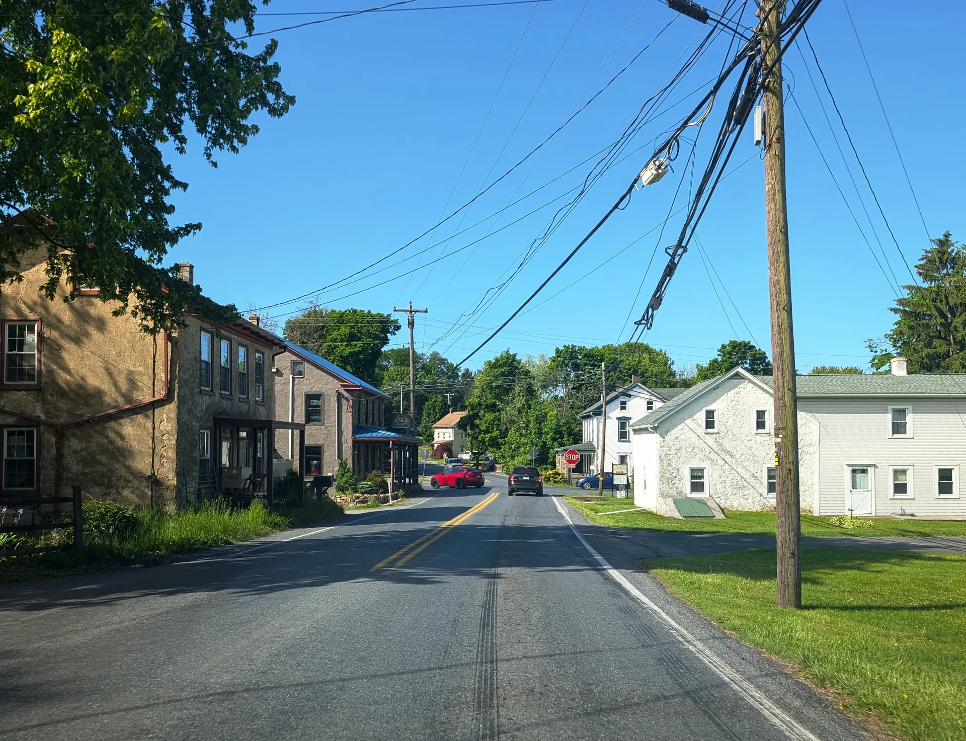 Lyons Road leads southwest through Dryville in Rockland Township, with old brick and frame houses lining the street.