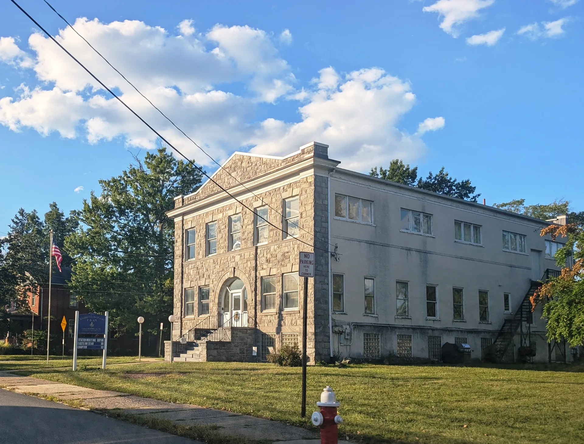 The Warren Lodge in Collegeville is a large stone building with tall windows, set behind a grassy lawn on East Main Street.