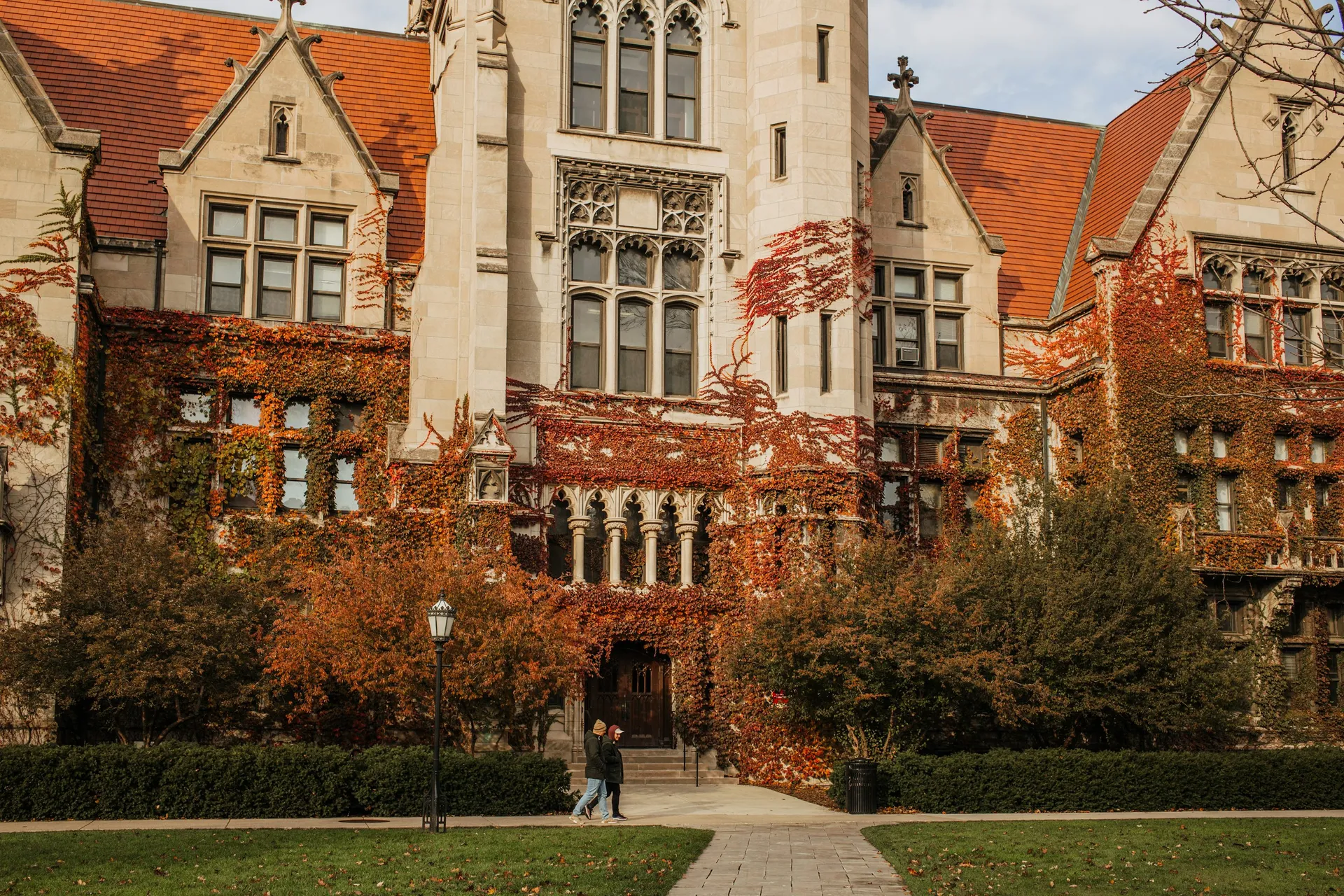 Gothic university buildings beside a green lawn on the University of Chicago campus.