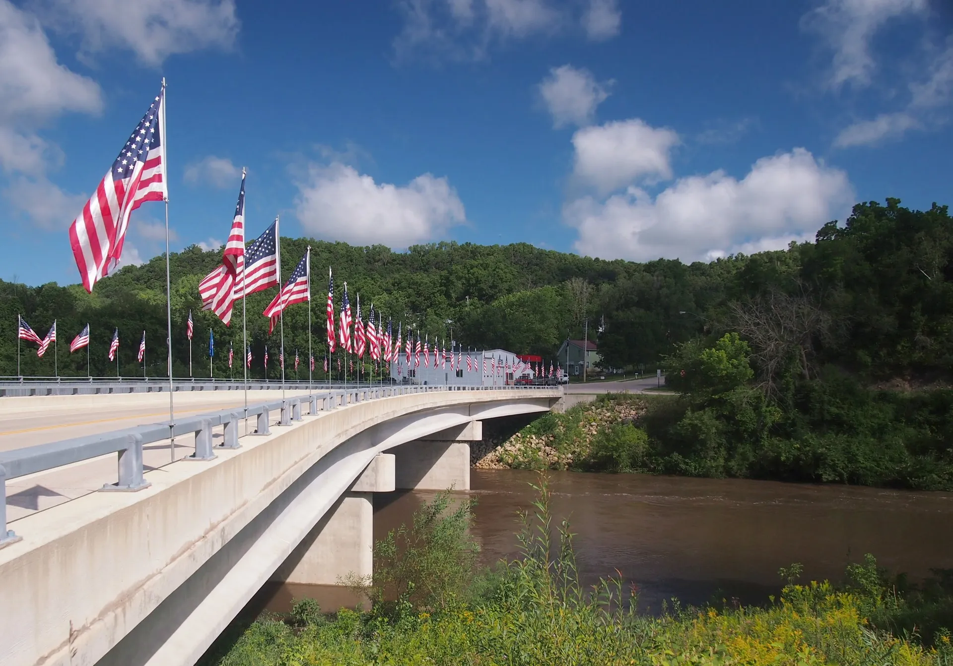 Bridge and flags along the river in Millville, Minnesota.