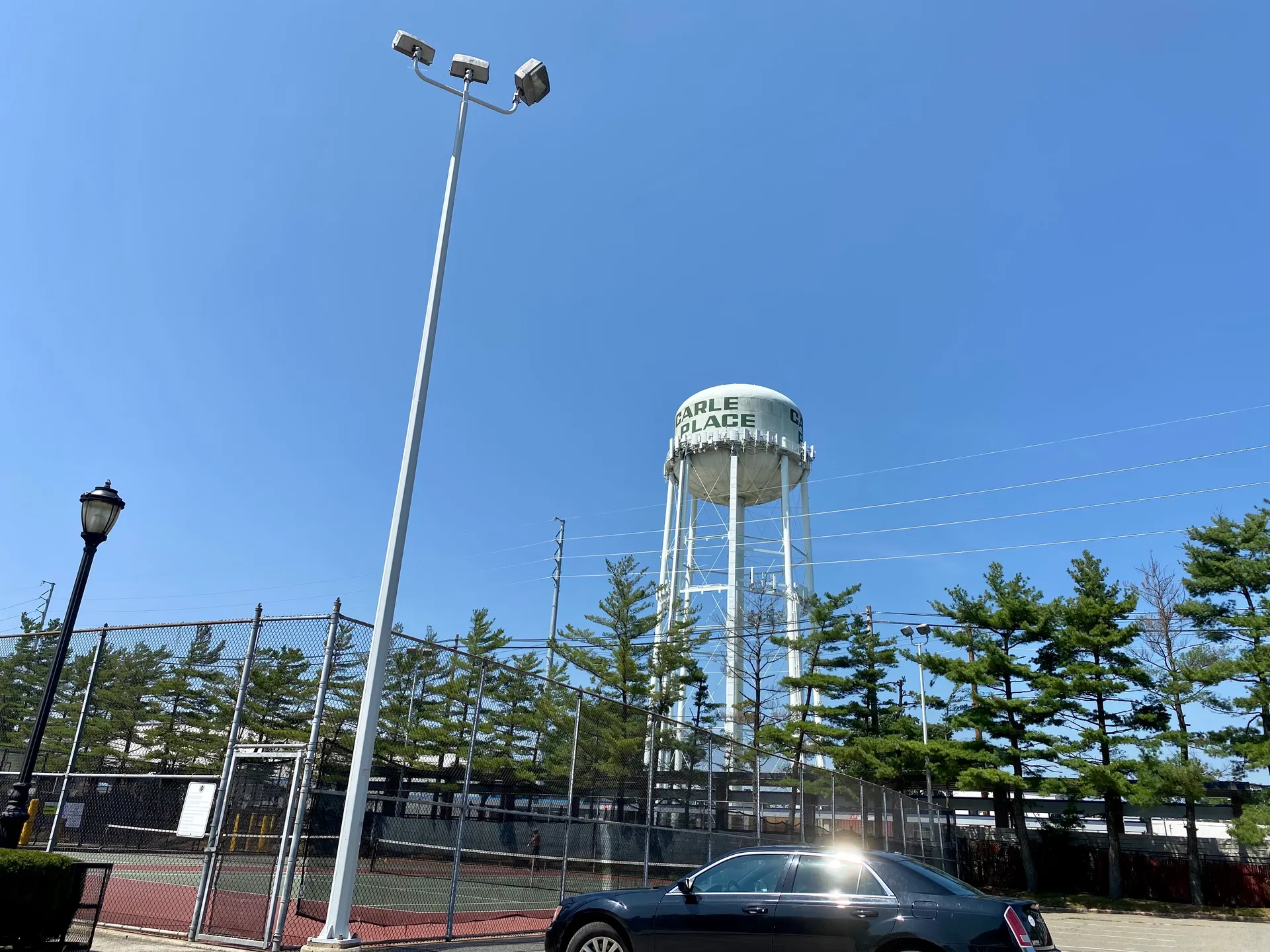 Carle Place water tower rising above trees in Carle Place, New York.