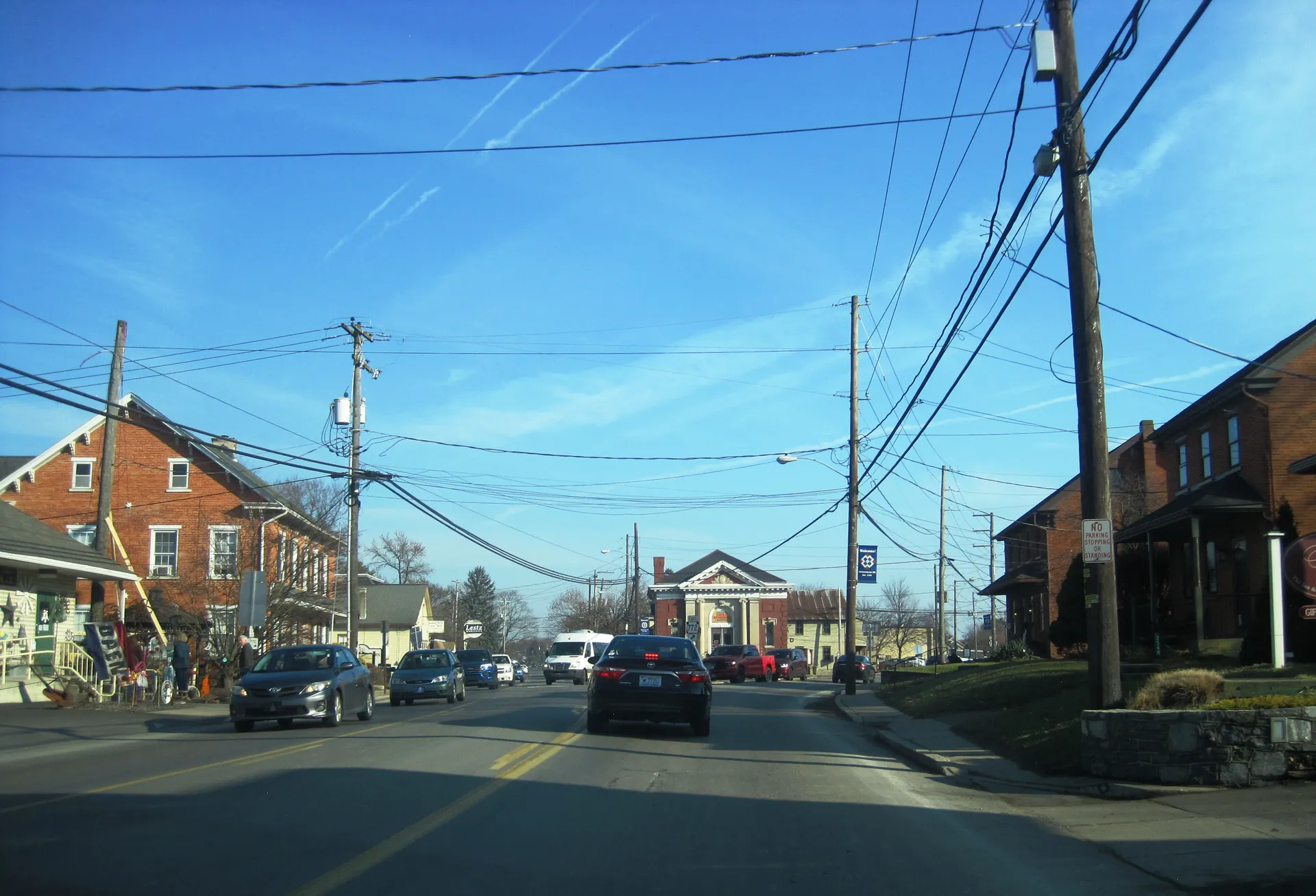 Old Philadelphia Pike runs east through Intercourse in Leacock Township, past brick buildings, shops and parked cars.