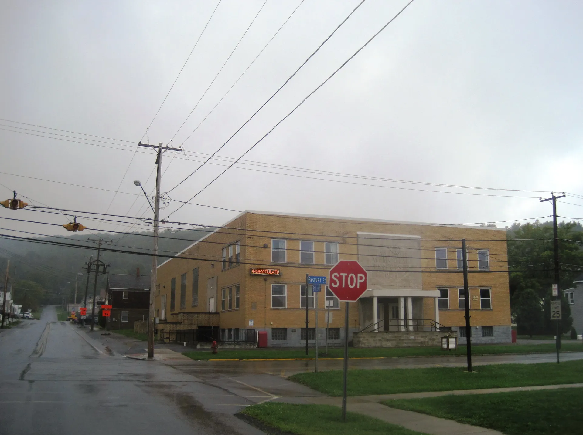 Hastings Memorial Building, a broad tan-brick community center, anchors the corner of 3rd Avenue and Beaver Street.
