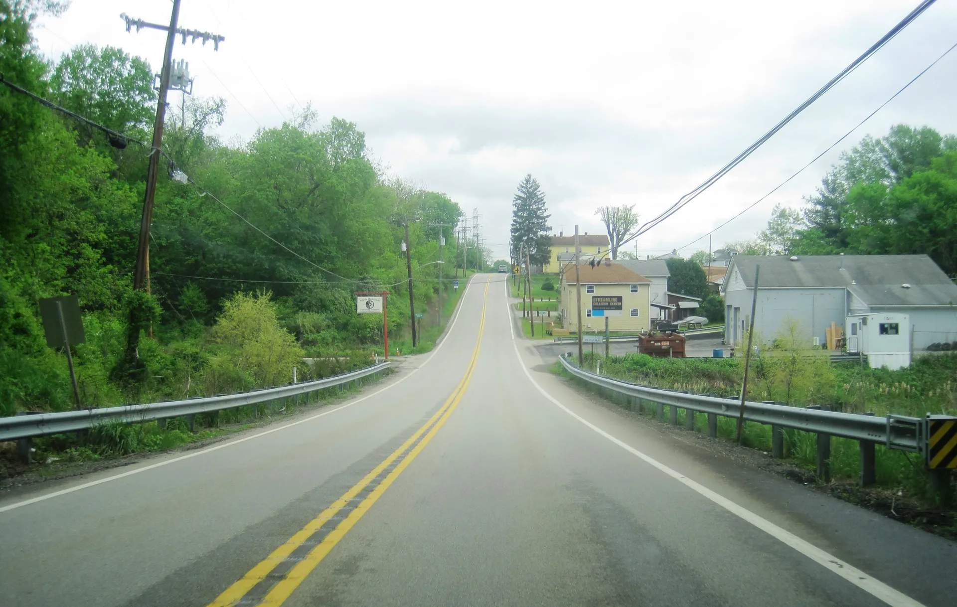 Route 837 heads northeast through Elrama in Union Township, Washington County, with houses on a green hillside.