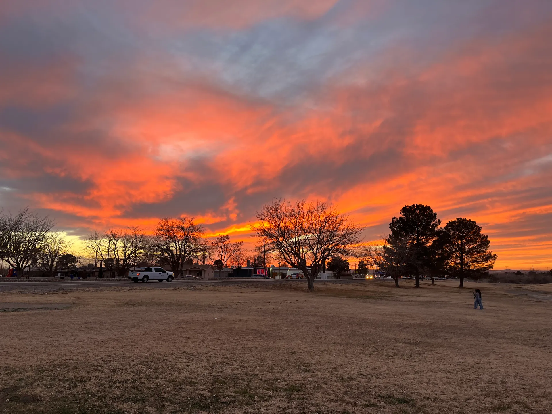 Vivid orange sunset over open land in Anthony, Texas.