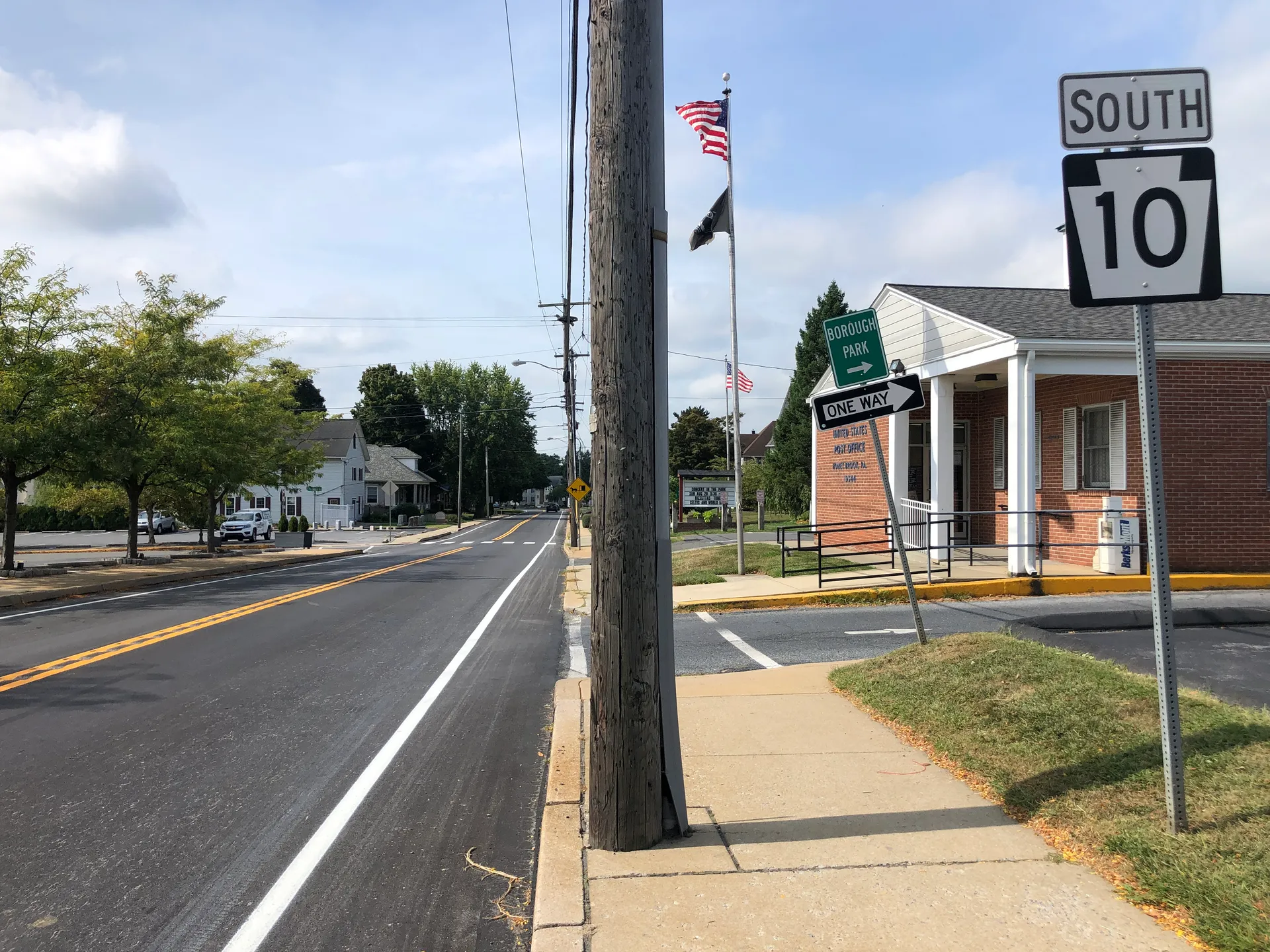 Just south of Horseshoe Pike, Pequea Avenue (Route 10) in Honey Brook passes a white-columned building with a flag.