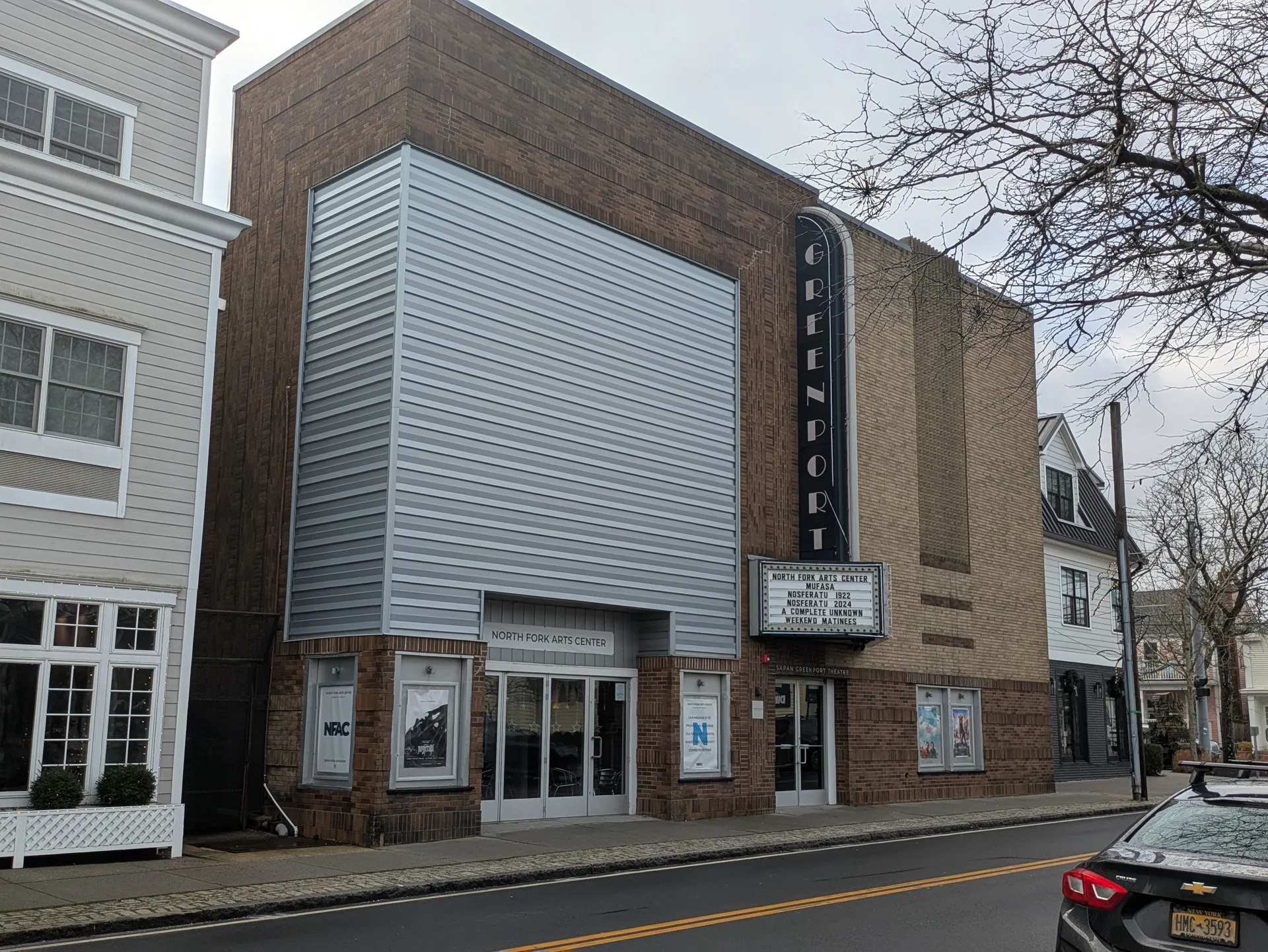 Historic Greenport Theatre with a vertical sign in Greenport, New York.