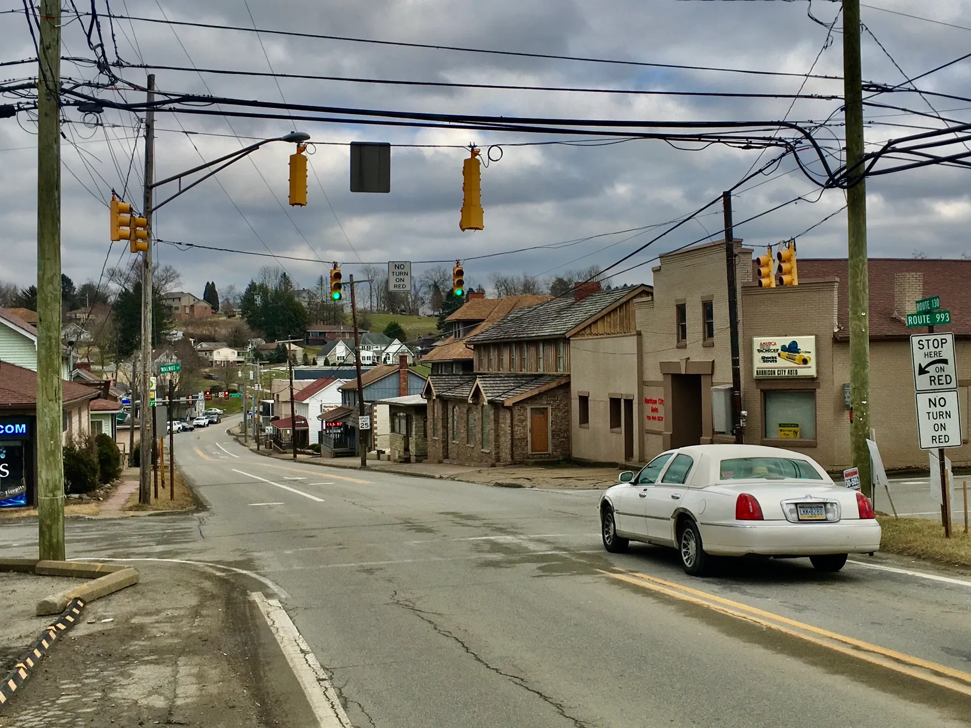 From Walnut Street, Harrison City-Jeannette Road leads east through Harrison City's small business district under traffic signals.