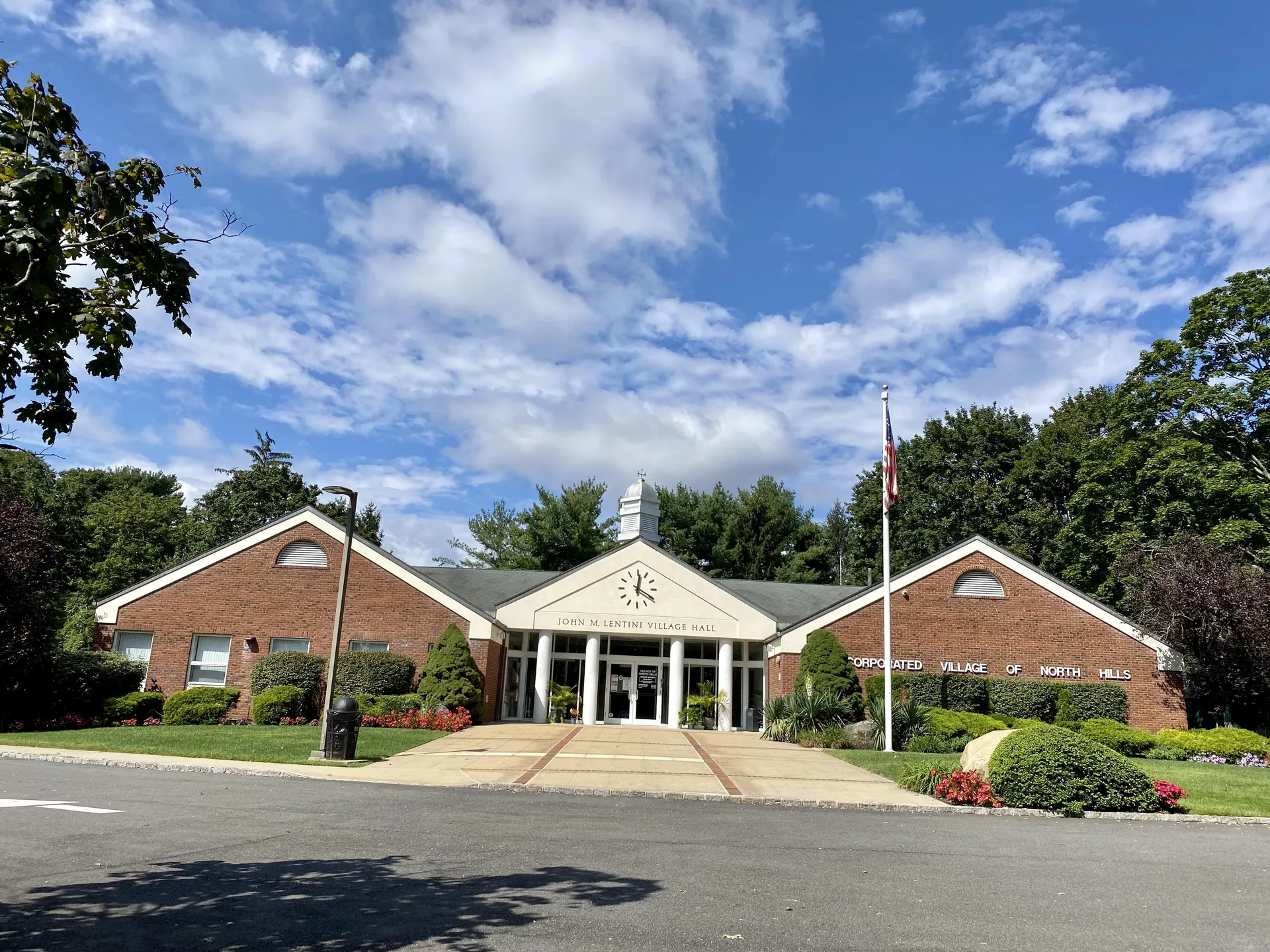 Brick North Hills Village Hall with landscaping in North Hills, New York.
