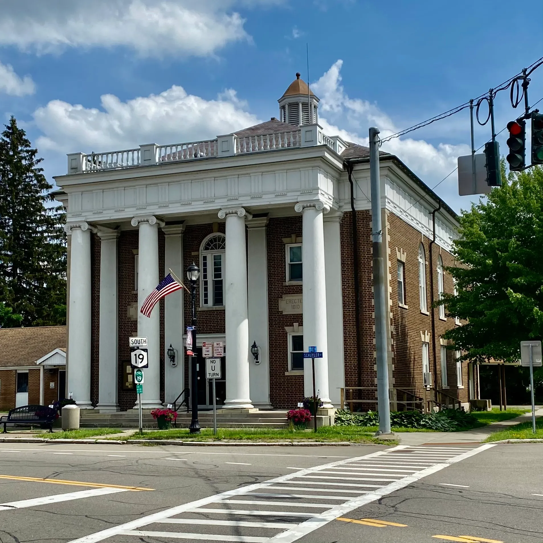 Columned Village Hall building on a corner in Belmont, New York.