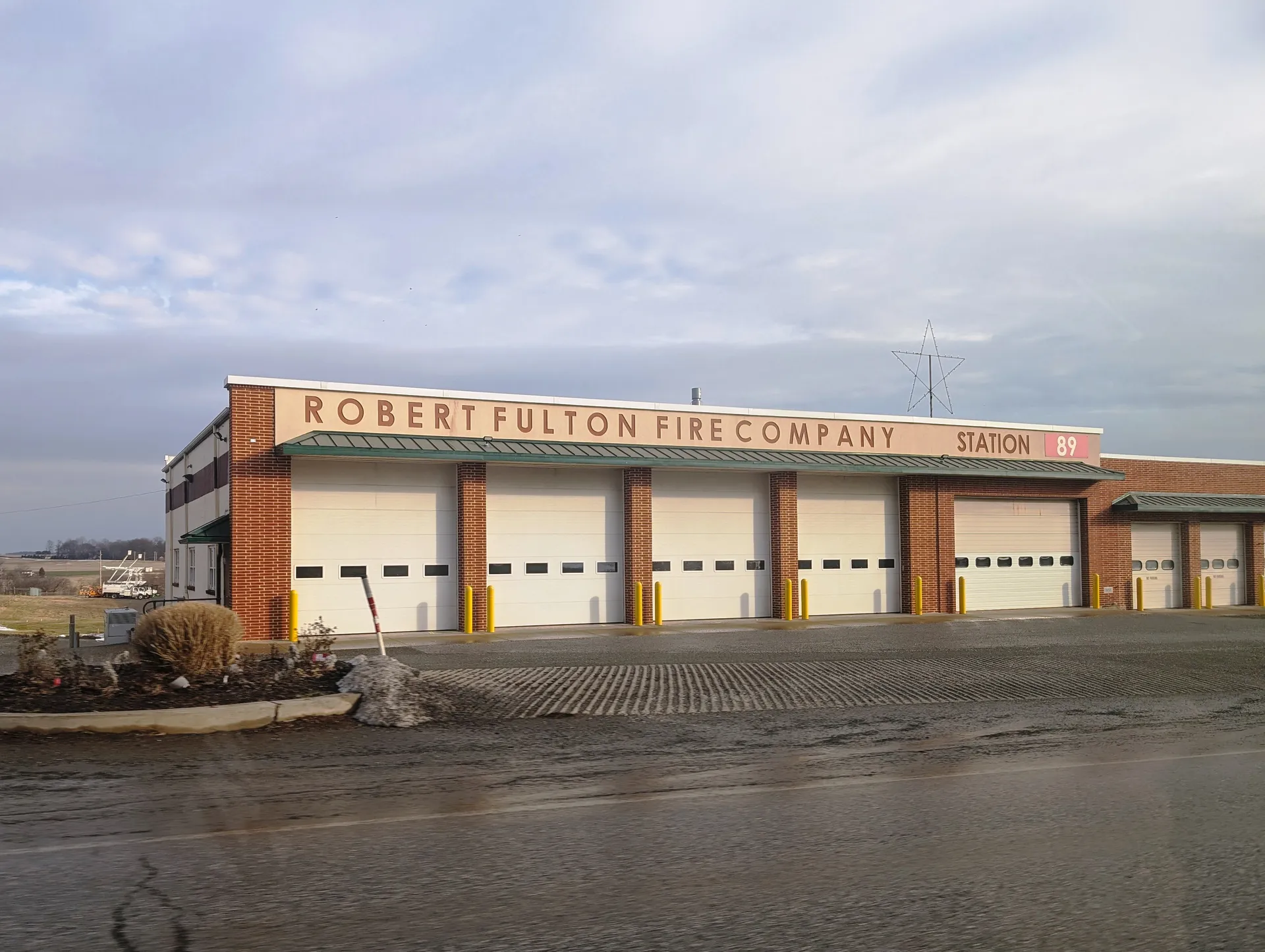 The Robert Fulton Fire Company Station 89 in Wakefield is a brick firehouse with six white bay doors along Robert Fulton Highway.