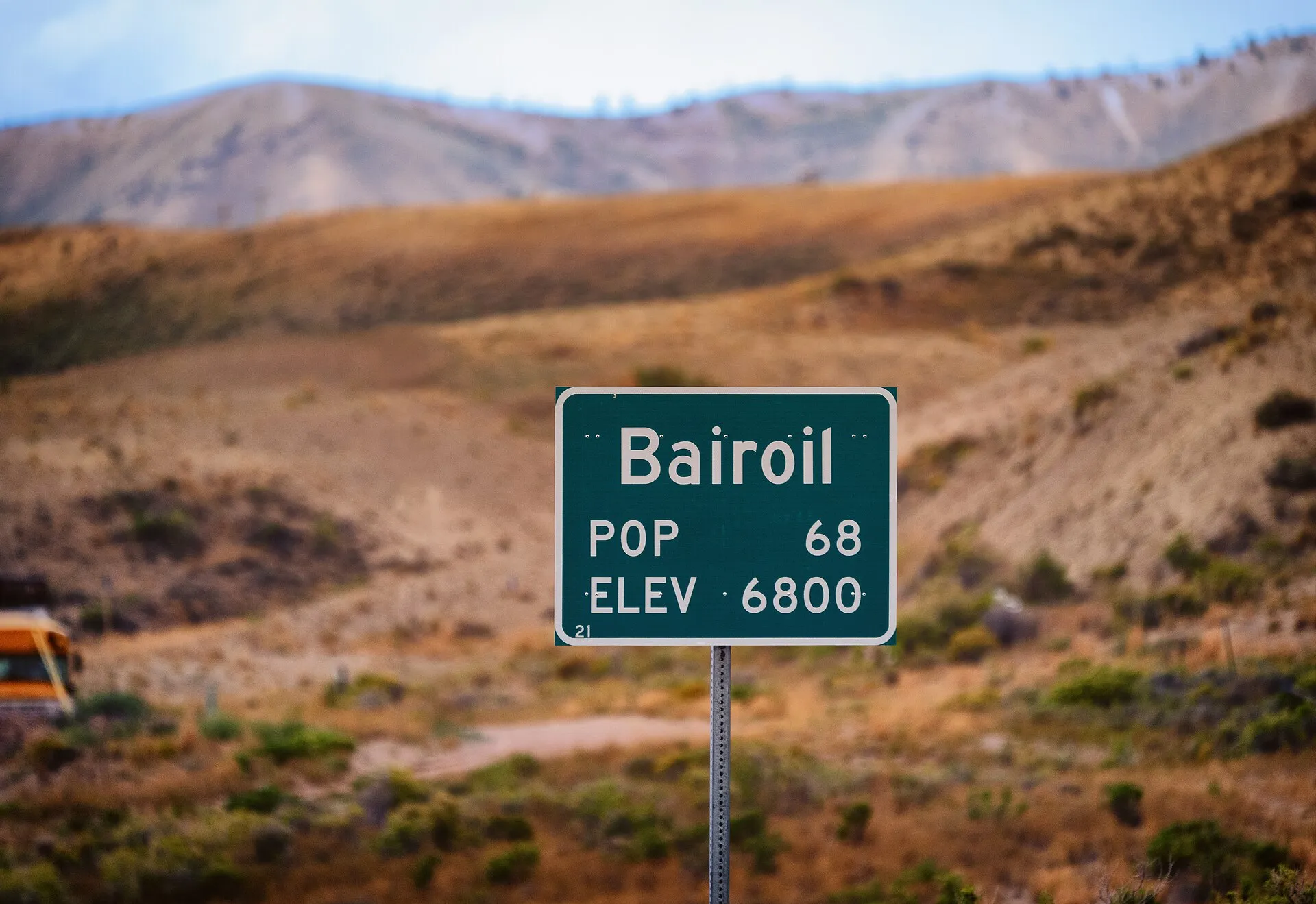 Bairoil population sign and sagebrush hills in Bairoil, Wyoming.