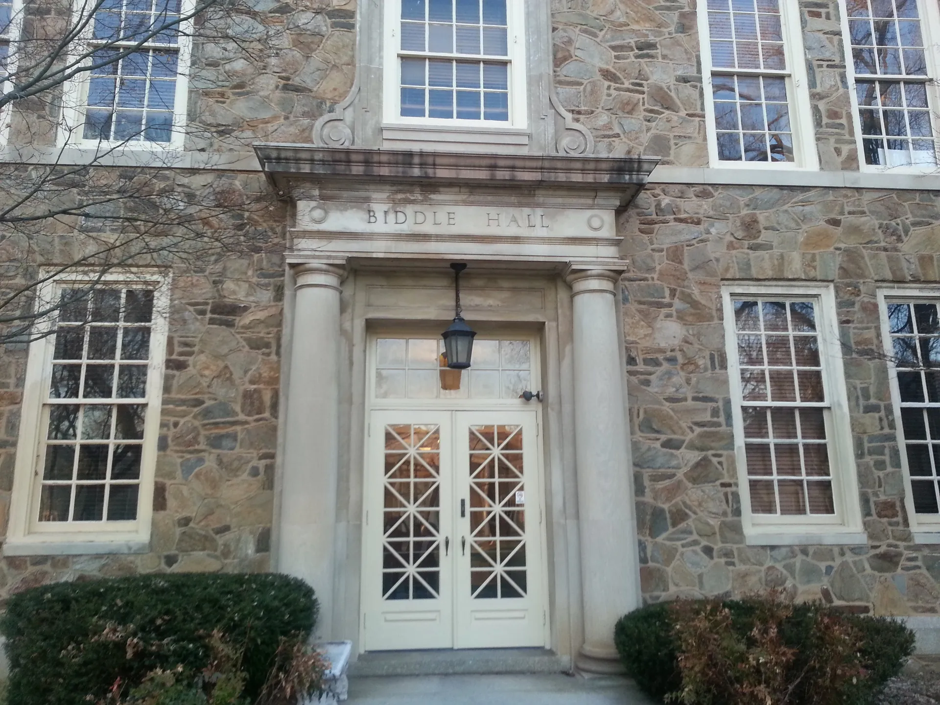 Biddle Hall on Cheyney University's historic quad has a fieldstone facade and a classical doorway with a lantern overhead.