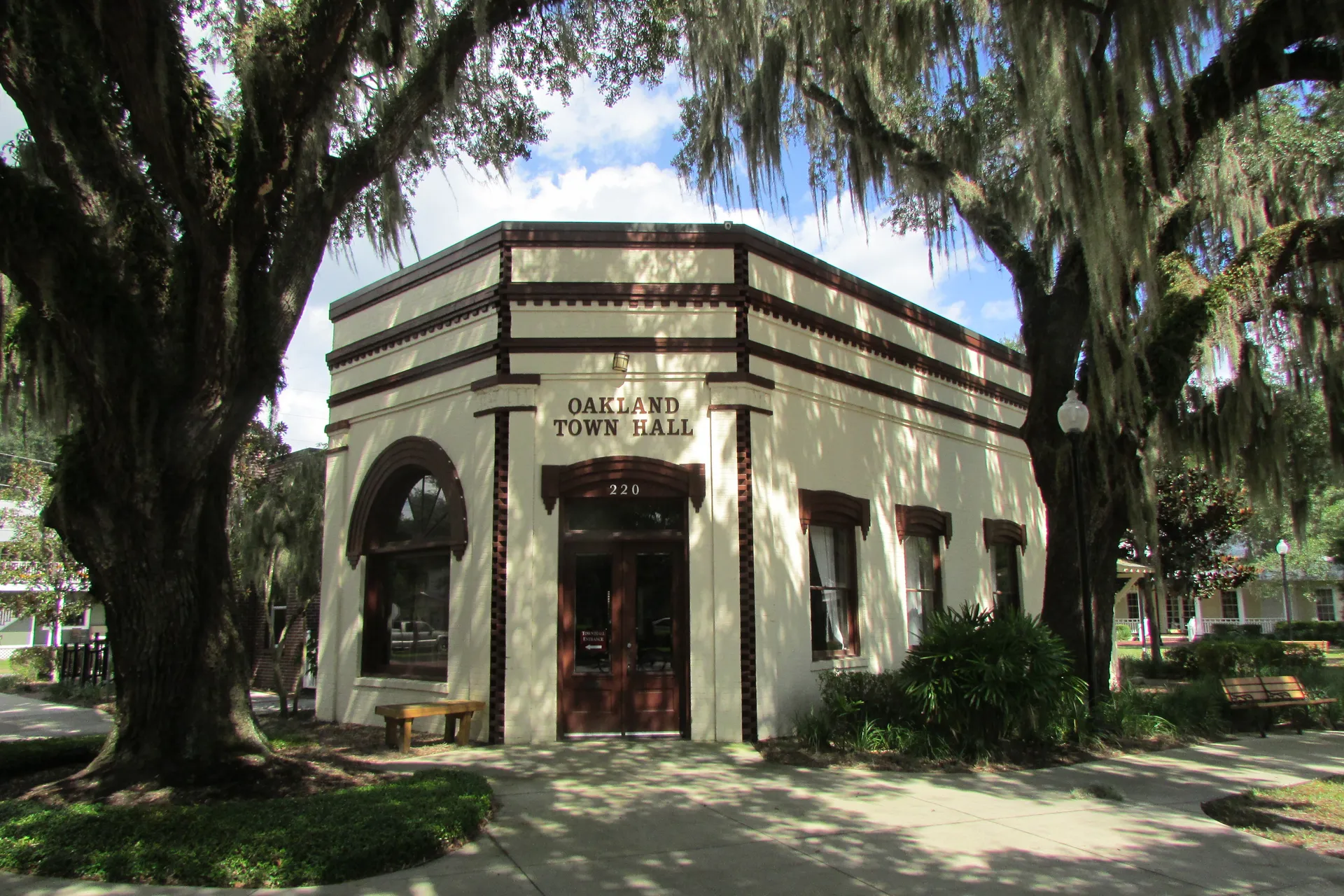 Oakland Town Hall shaded by oak trees in Oakland, Florida.