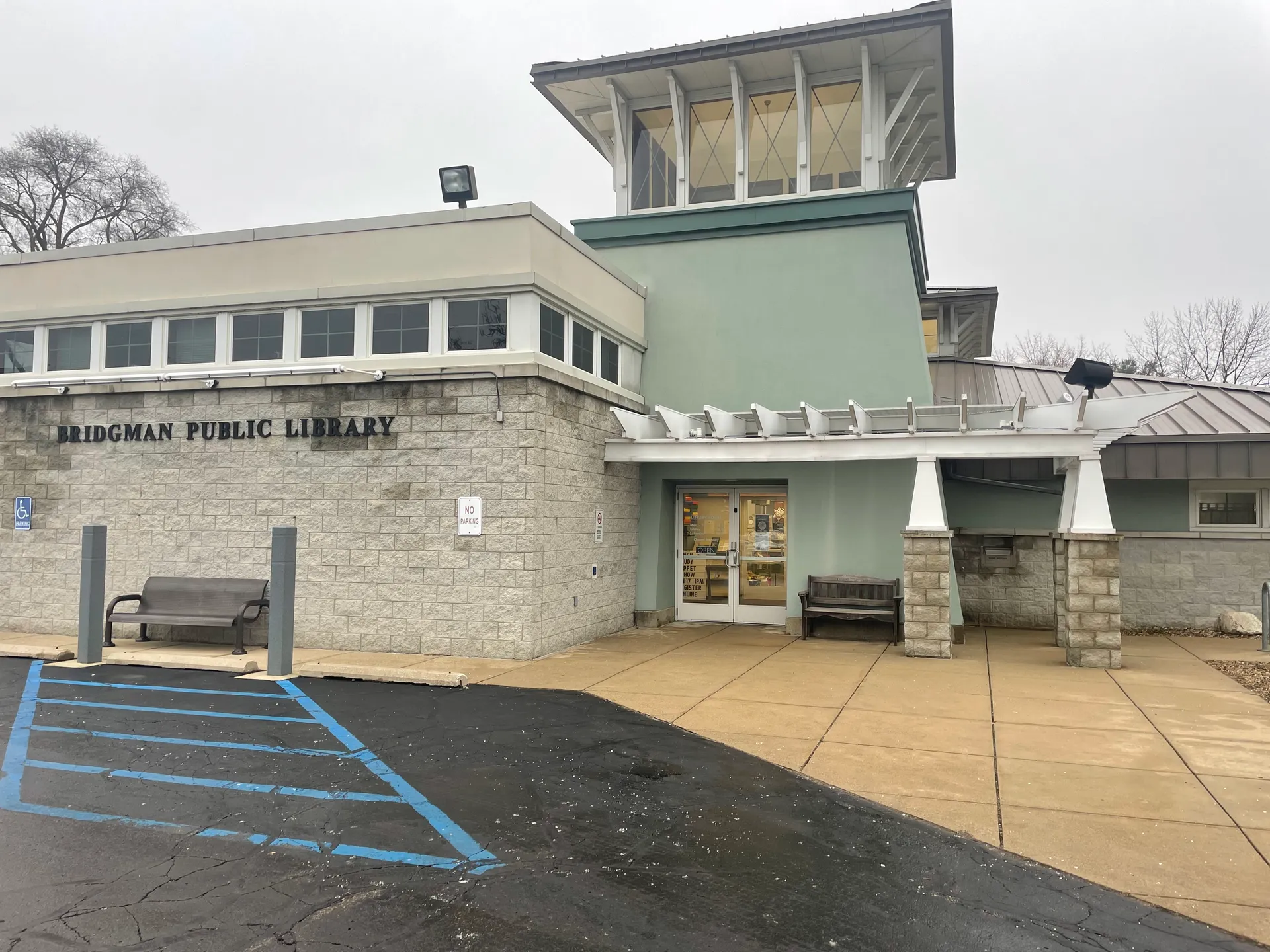 Bridgman Public Library combines a fieldstone base with pale green upper walls and a raised lantern-like tower over the entrance.