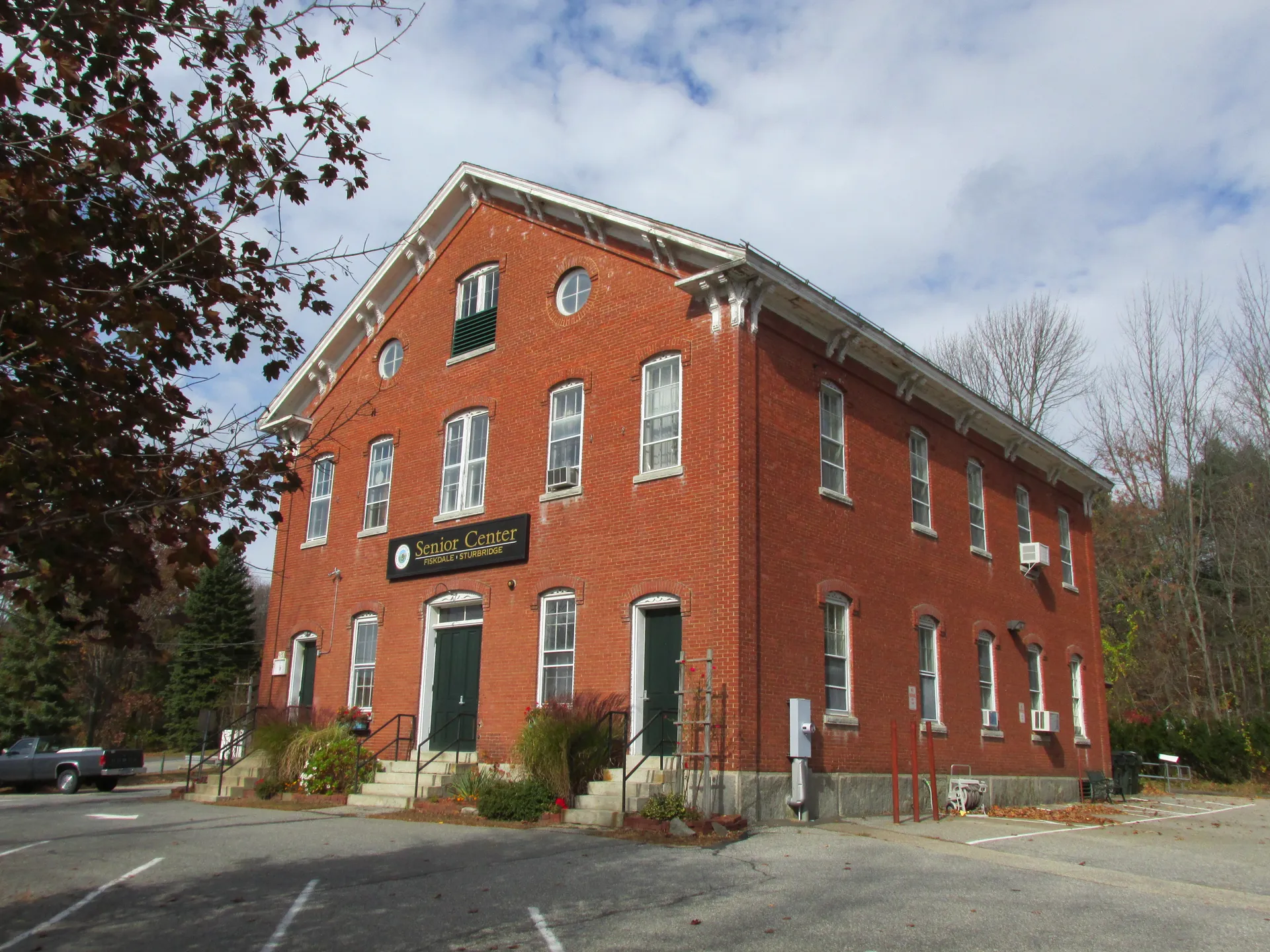 Historic red brick building housing the Senior Center in Sturbridge, Massachusetts.