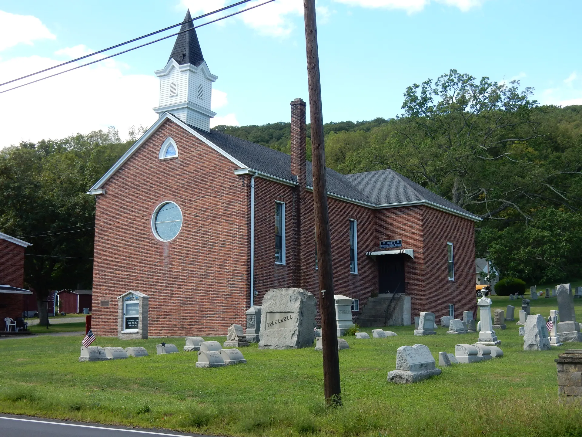 Christ Congregational Church in Fountain Springs is a red-brick church with a white belfry, set amid its old cemetery.